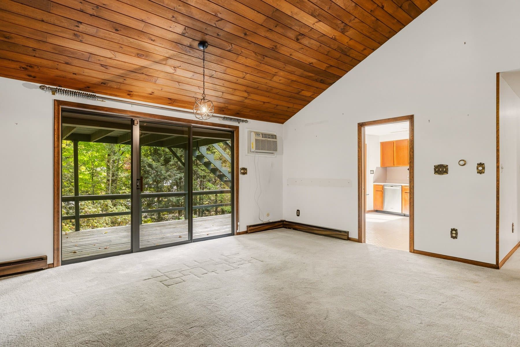The slider from the living room to the deck, with the kitchen doorway beside it